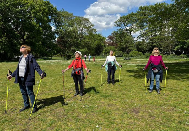 Women Nordic Walking in a park