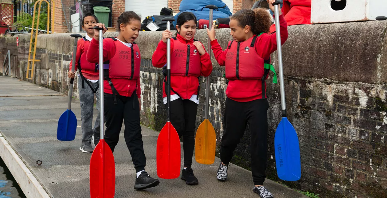 Children with canoe paddles at Shadwell Basin